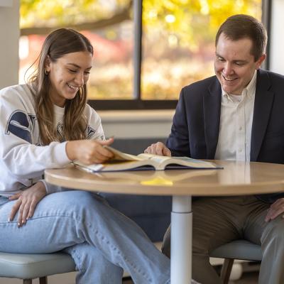 Student and teacher sitting at table